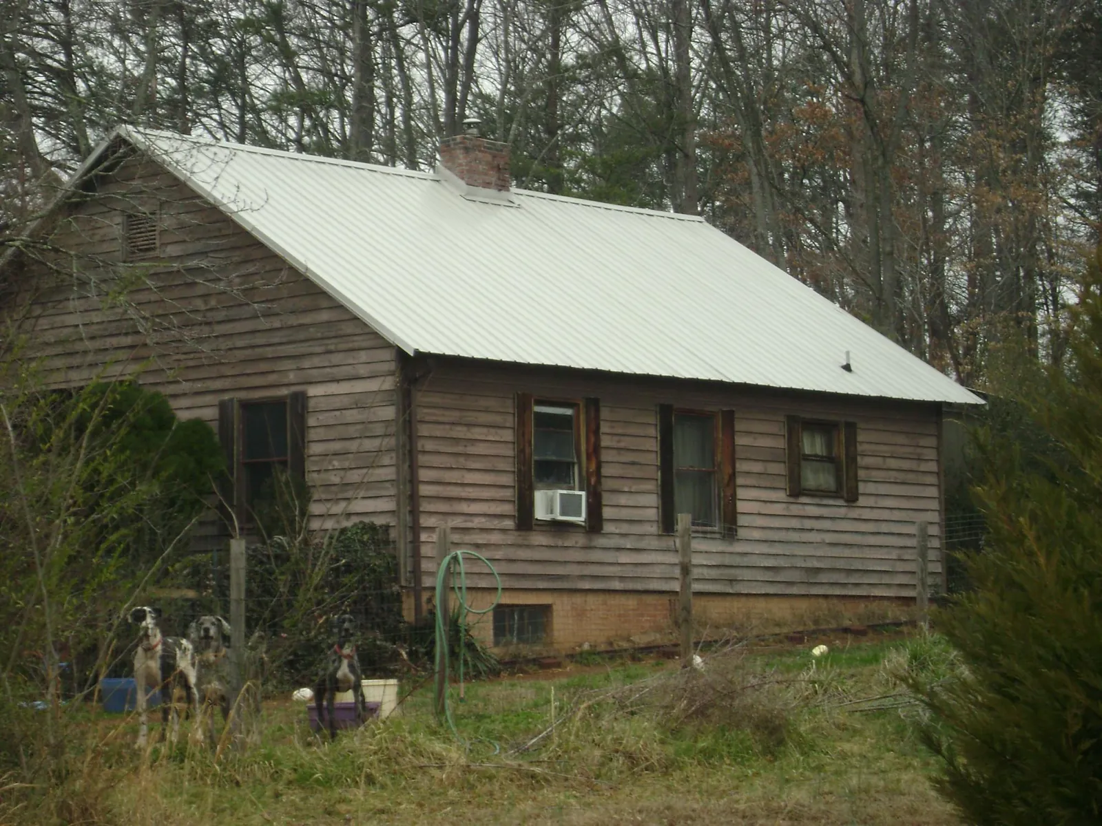 White metal roof on an old wood sided farmhouse, from a Metal Roof Installation job in Grandview